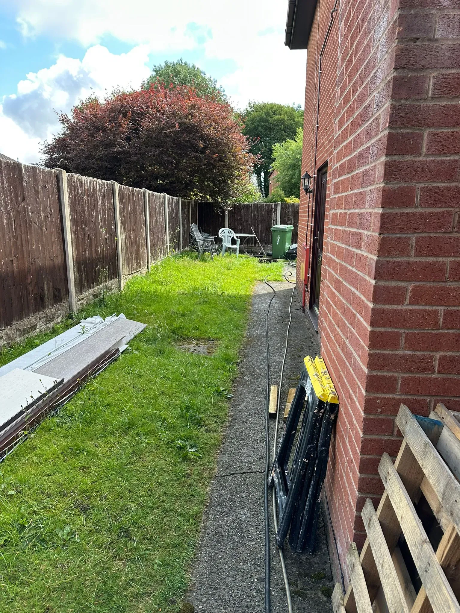 Side of a house and garden, depicting a residential property where Clear Blocked Drains handles blocked drains and other drainage issues.